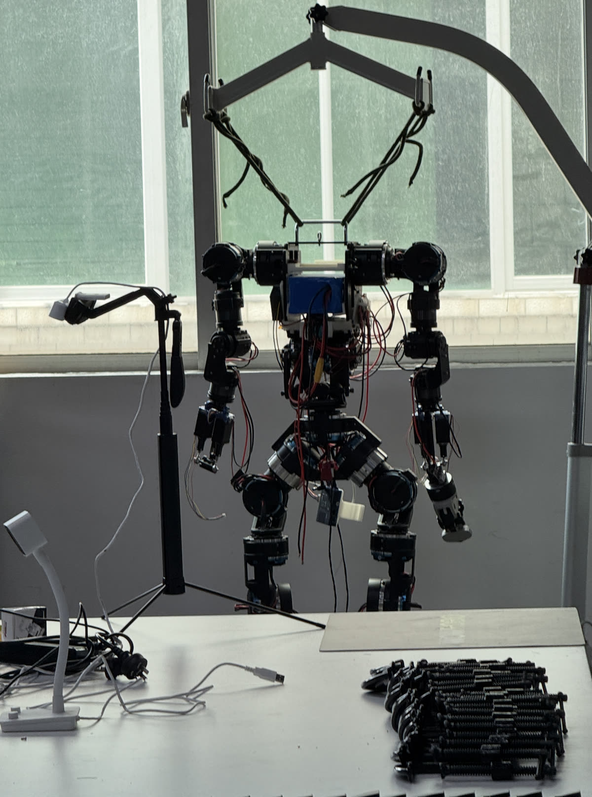 A humanoid prototype skeleton on a factory workbench in Shenzhen